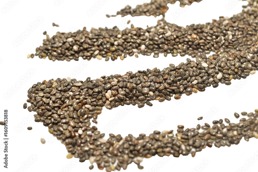 Chia seeds are scattered on a white table surface. Chia seeds are scattered on a white table surface.