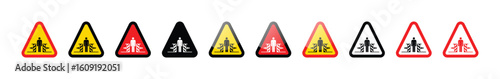 A row of triangular safety signs warning of crushing hazard in various colors