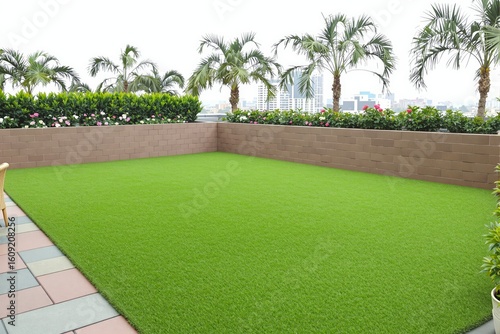 Lush artificial lawn on a rooftop terrace with palm trees.