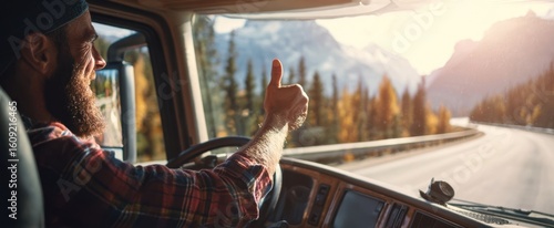 The happy truck driver enjoying a scenic drive through the mountains.