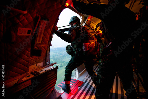 Paratroopers Ready for Jump
,Soldiers preparing to jump from a military aircraft, capturing the intensity and focus before a parachute training mission.