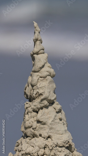 Photography Sandcastle stupa on beach blurry background.