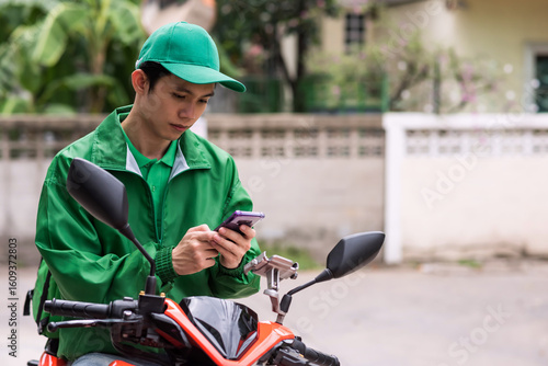 courier deliveryman on motorbike receive food order from phone
