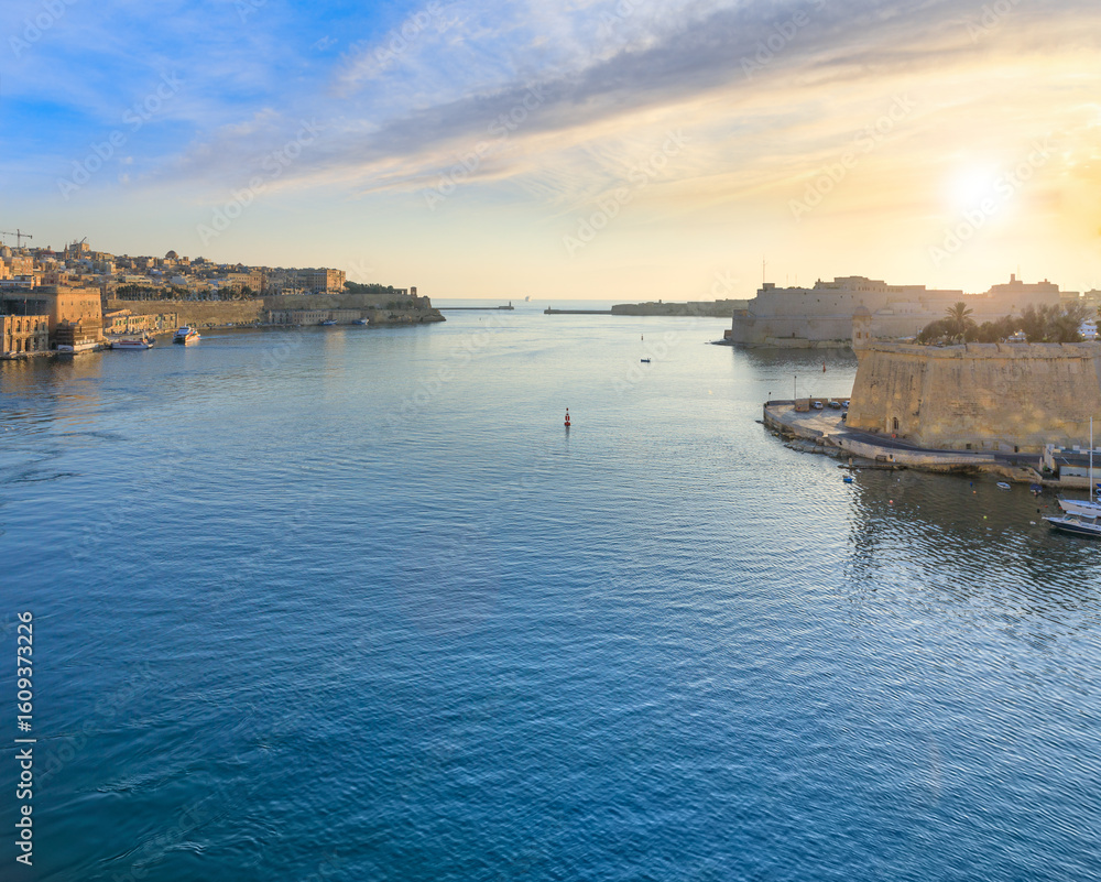 Fototapeta premium Sunrise view of Grand Harbour seascape in Valletta, capital of Malta. View of Fort St. Angelo, a bastioned fort in Birgu, located at the centre of the Grand Harbour. 