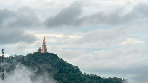 Landscape view of Wat Pa Phu Thap Boek. Temple located on a hilltop with a dense green forest covering. Amidst the mist and white clouds as a background.At Phu Thap Boek Phetchabun Thailand.