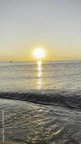 Golden sunrise at the seaside, romantic atmosphere, stunning nature. Vertical 4k footage