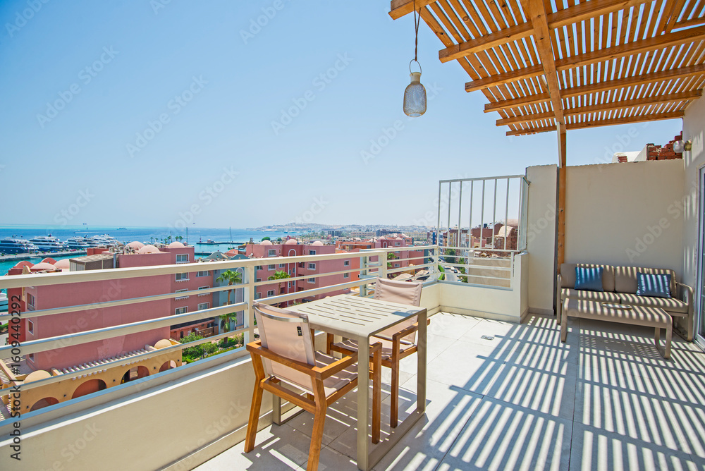 Fototapeta premium Roof patio terrace with chairs in tropical luxury apartment resort