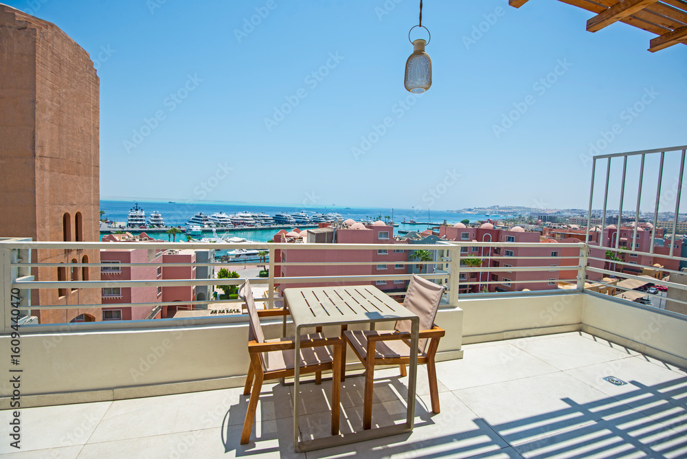Fototapeta premium Roof patio terrace with chairs in tropical luxury apartment resort