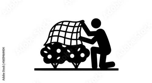 A man covering bushes black