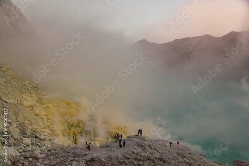 Sunrise image of tourists at Kawah Ijen, a beautiful turquoise crater lake in the stratovolcano Mount Ijen, located in East Java, a province on Indonesia's Java island
