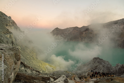 Sunrise image of tourists at Kawah Ijen, a beautiful turquoise crater lake in the stratovolcano Mount Ijen, located in East Java, a province on Indonesia's Java island