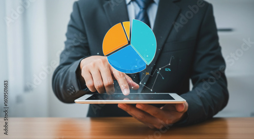  Businessman Analyzing Pie Chart on Digital Tablet, Representing Business Data and Analytics