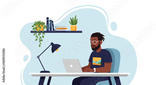 African American man working on laptop at home office, ideal for productivity, remote work, or freelance concepts.