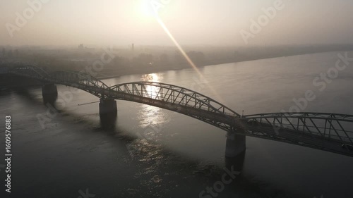 Drone video of the bridge over the Danube River in the city of Komárno, which connects Slovakia and Hungary. Aerial footage of the river, bridge and autumn landscape with fog.