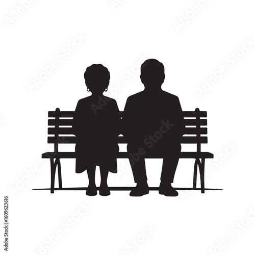 Silhouettes of an elderly couple sitting together on a park bench representing enduring love and companionship