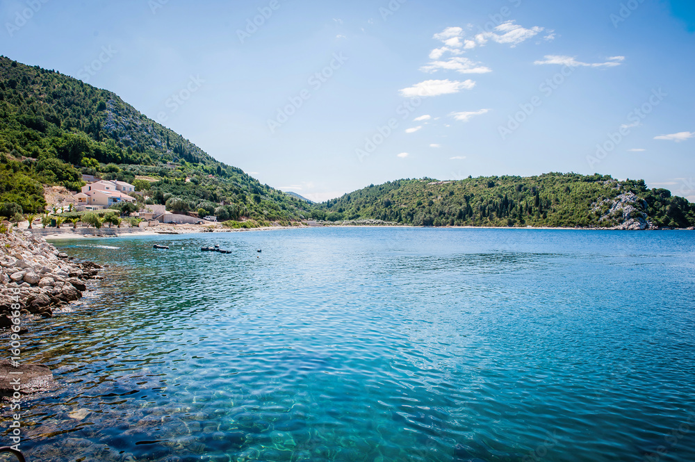Fototapeta premium Scenic Adriatic coastal landscapes with clear blue sea, rocky beaches, pine trees, and tranquil bays