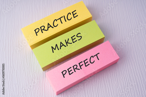 Colorful sticky notes with text practice makes perfect on white background
