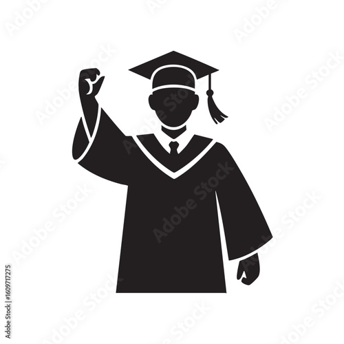 Graduate wearing cap and gown raising fist in celebration graduation tassel