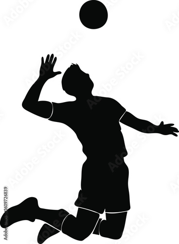 Silhouette of a male volleyball player jumping to spike the ball

