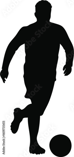 Silhouette of a soccer player dribbling the ball
