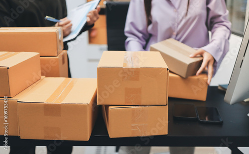 Portrait of Starting small businesses SME owners, two Asian woman check online orders Selling products working with boxs freelance work at home office, sme business online small medium enterprise