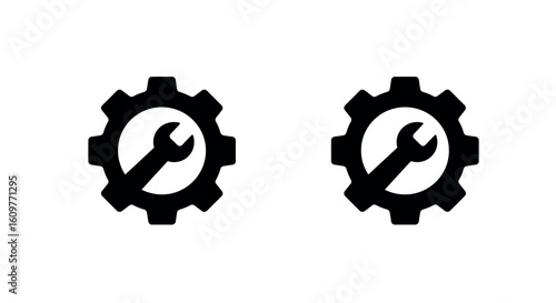 Two silhouette gear icons with wrench symbol inside for settings or maintenance