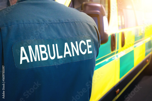 Ambulance and paramedic - emergency services worker and ambulance vehicle on standby. Medically equipped for patients and paramedics. Transport for health care facility or hospital, for treatment.