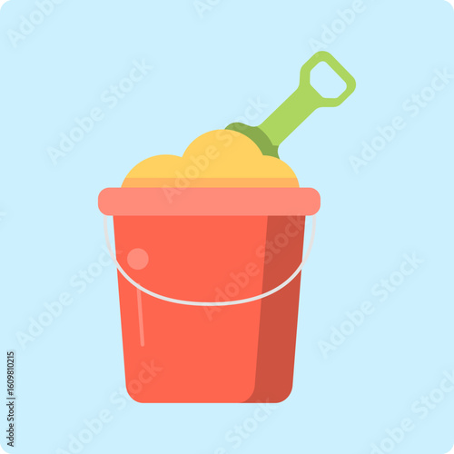 Red sand bucket filled with sand and green shovel
