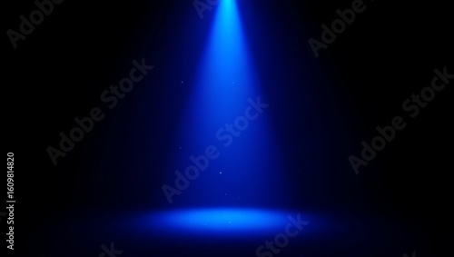 Bright blue spotlight illuminating a dark stage with a circular pool of light