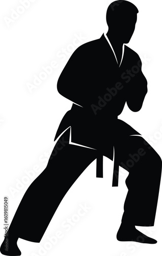 Black silhouette of a person in martial arts uniform in a defensive stance karate