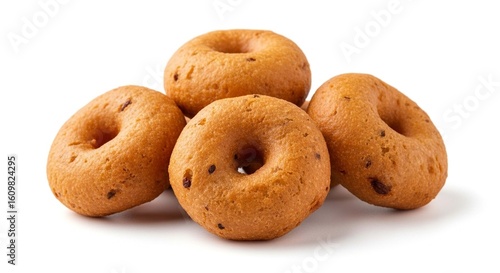 A small pile of four golden brown savory ring-shaped fritters isolated on a white background.