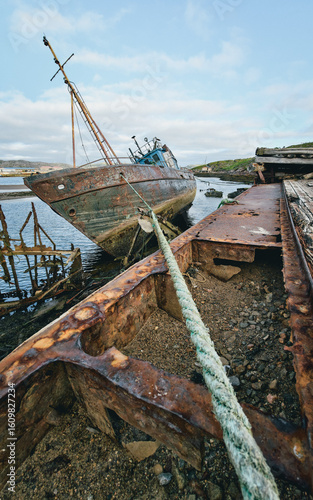 old abandoned sunken ship in the water at the ship cemetery wood pattern