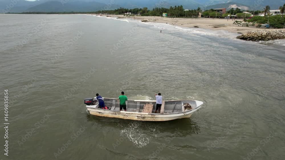 Fishermen navigating coastal waters in small motorboat Fishermen navigating coastal waters in small motorboat