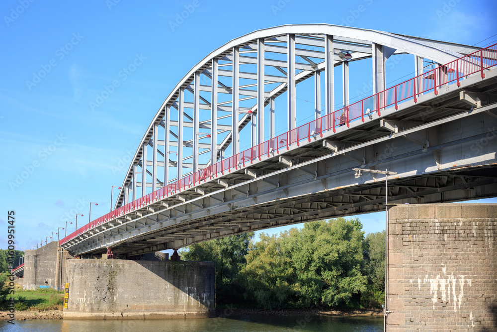 Obraz premium Arnhem bridge is situated on the banks of the Nederrijn, which is a branch of the Rhine River. It is famous for Operation Market Garden during WWII
