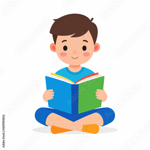Happy boy engrossed in reading a colorful book while sitting cross-legged on the floor.