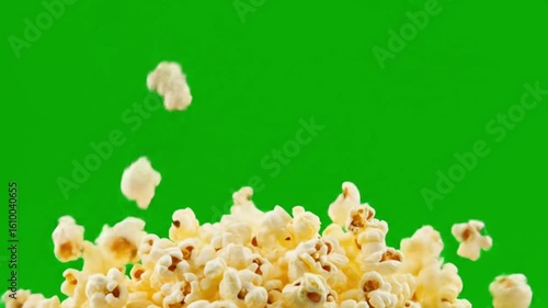 Falling popcorn against a green screen background creating a dynamic and fun visual effect for viewers