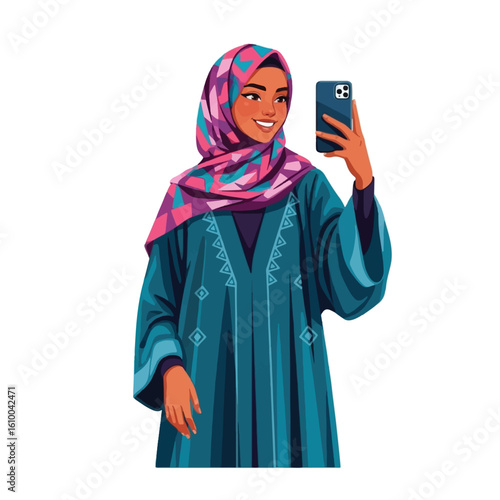 A smiling woman in a teal abaya and patterned hijab takes a selfie with her smartphone.