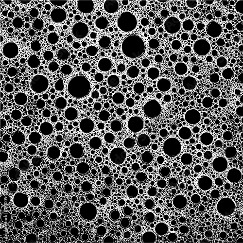 A dense arrangement of black circles surrounded by white foam like structure creating a pattern