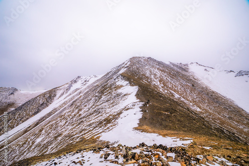 Snowy Mountain Ridge Under Overcast Sky