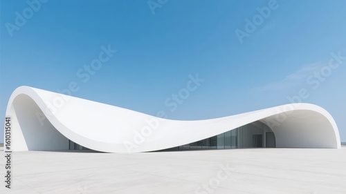 Modern White Architectural Structure with Curved Design Under Clear Blue Sky