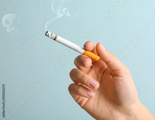 Hand holding a lit cigarette with curling smoke rising upwards