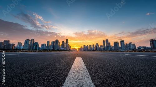 Stunning city skyline at sunset with clear open road leading towards vibrant horizon and skyscrapers in the background.