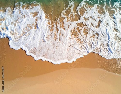 Aerial View of Ocean Foam on Sandy Shore: Top Down Perspective of Sea Wave Splashing Beach for Nature, Travel, and Coastal Landscape Concepts