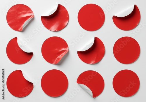 A collection of eight red, crumpled, circular stickers