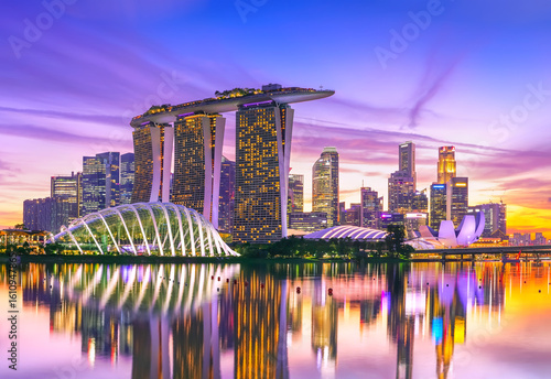 View of the skyline at the Downtown Core along Marina Bay at dusk in Singapore.