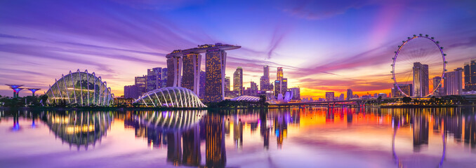 View of the skyline at the Downtown Core along Marina Bay at dusk in Singapore.