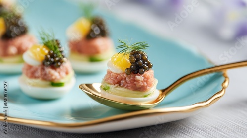 Gourmet appetizers featuring tartare and caviar served on sophisticated spoons at an elegant dining event in the spring