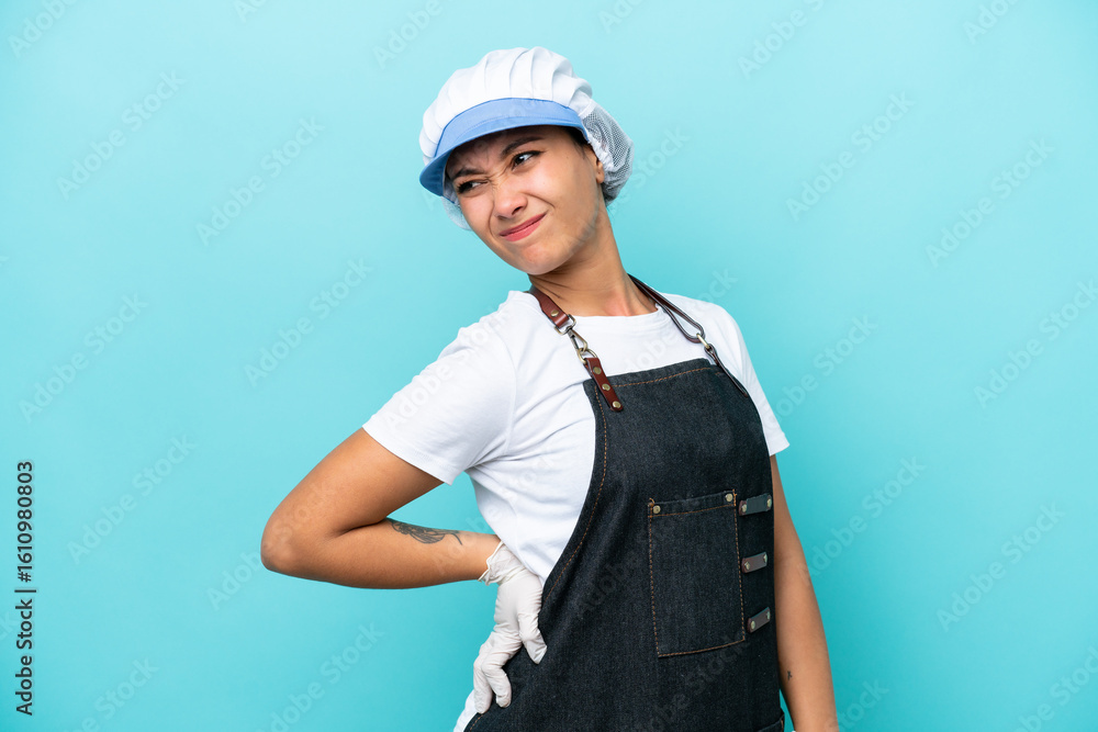 Fishwife Argentinian woman isolated on blue background suffering from backache for having made an effort Fishwife Argentinian woman isolated on blue background suffering from backache for having made an effort