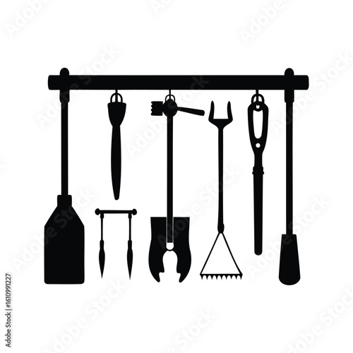 Silhouette of assorted garden and tool implements hanging from a metal bar