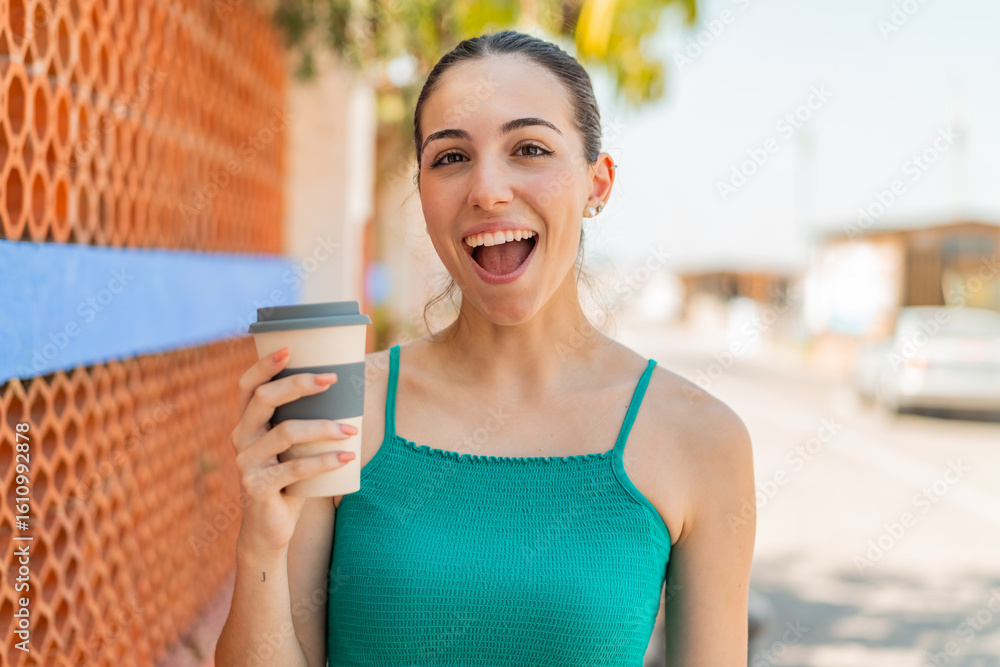 Young pretty woman holding a take away coffee at outdoors with surprise and shocked facial expression Young pretty woman holding a take away coffee at outdoors with surprise and shocked facial expression